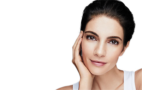 Model with hair pulled back resting chin in hand against a white background.
