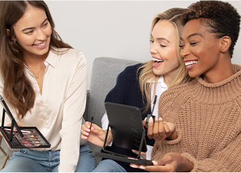 A group of women joyfully interacting during a Mary Kay makeup party