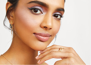 A medium skin toned model wearing winged eyeliner