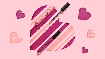 Limited-edition Mary Kay Unlimited Lip Gloss shades arranged in shape of a heart with a closed tube and open tube and applicator.