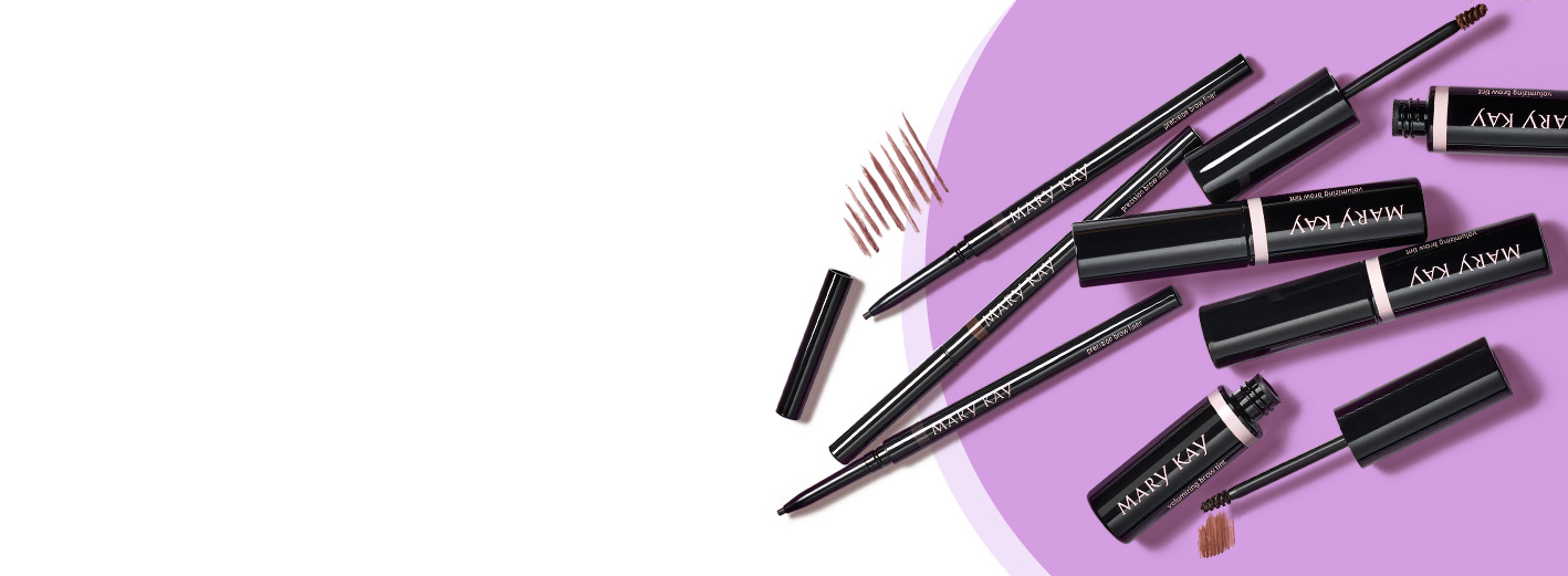 Several Mary Kay Precision Brow Liners and Mary Kay Volumizing Brow Tints with product rubs atop purple circle