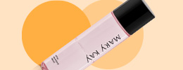 Mary Kay Oil-Free Eye Makeup Remover in front of two orange circles