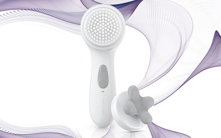 Mary Kay Skinvigorate Sonic Skin Care System shown with Facial Massage Head attachment alongside it and graphic blue and purple swirls illustrating sonic technology.