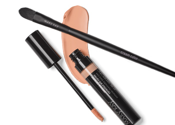 Mary Kay concealer in light tone and Mary Kay eye shadow brush on top of concealer rub in nude color on a white background.