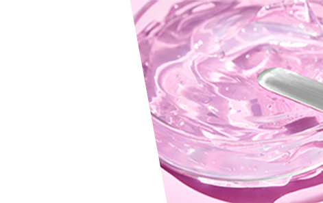 A clear gel skin care product in a glass dish on a pink background