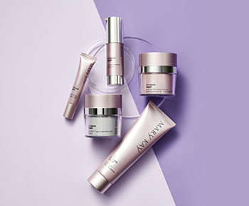 The TimeWise Repair skin care regimen in purple and gray tubes and jars on a purple background