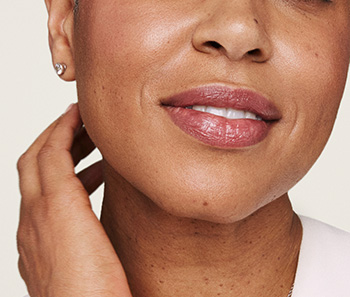 Close-up lower half of slightly smiling mature model’s face