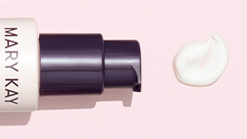 An open TimeWise Daytime Defender SPF 30 next to a dime-sized dollop of product on a light pink background